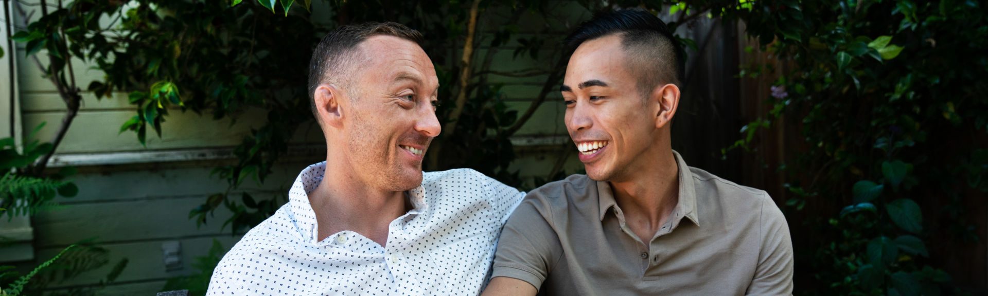 two men staring at each other and smiling